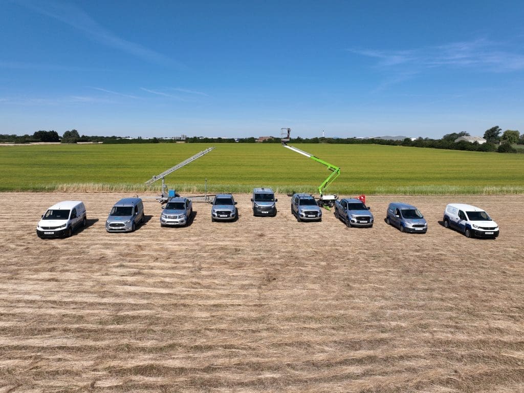 Aerial image of Sky Revolutions vehicles lined up with 30m mast and cherry picker behind them